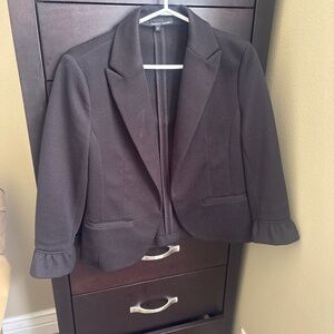 Black blazer with mid-length sleeves.